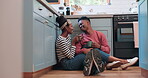 Kitchen floor, tea cup and black couple smile, wellness and bonding chat about love, support or relationship. Home, relax morning and people talk about coco hot chocolate, espresso or latte drinks