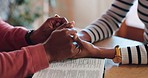 Closeup, holding hands and bible for faith in religion, worship and prayer in home. Black man, woman and married with care, support and trust in `God for spiritual wellness for self care at table
