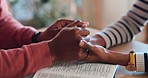 Couple, together and holding hands with bible in home for worship, prayer or peace for bond in closeup. Man, woman and married for faith, spiritual or respect for religion by support, trust or love