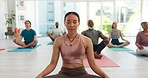 Meditation, yoga club and people in lotus pose at gym for fitness or peace, zen or mental health balance. Breathe, exercise or woman guide with group for energy workout, wellness or holistic training