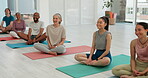 People, group and yoga on mat in studio for fitness, exercise or workout with zen, wellness and happiness. Pilates, men or women on floor for training, stretching or lifestyle class with smile or joy