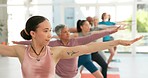 Woman, coach and yoga class in warrior pose, pilates or training workout for indoor exercise together. Female person, yogi or mentor coaching people in body warm up or stretch for health and wellness