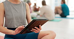 Hands, tablet and yoga with a person in the gym for fitness, wellness or workout research. Technology, fitness or exercise with a yogi closeup on the floor of a class for balance or inner peace