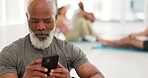 Senior man, yoga and floor with phone, reading and thinking for communication, texting or web blog. Elderly person, smartphone and scroll for social media app, training video or fitness in retirement