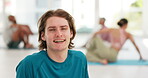 Man, face and smile with yoga for fitness, exercise or wellness in gymnasium or center with happiness. Person, portrait and guy for pilates, workout or training in gym or studio for mental health