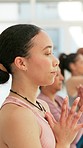 Yoga, meditation and woman with prayer hands in class for mindfulness, peace or calm. Meditate, yogi group and person in namaste pose for fitness, holistic exercise and healthy body, wellness and zen