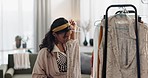 Woman, fashion designer and clothing rack in small business ecommerce or inspection at home. Creative female person looking at fabric, inventory or checking stock at retail boutique store for startup