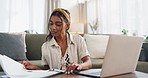 Woman, documents and laptop for home planning, online research and financial management or taxes report. Young worker or freelancer typing on her computer with paperwork, loan application or bills