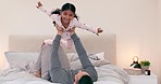 Happy, airplane and girl child with father on a bed for fun, games or bonding at home together. Flying, love and excited kid with parent in a bedroom with lifting, support and playing in a house