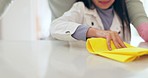 Father, child and hands wipe kitchen table, cleaning and hygiene, disinfection and health at home. Chores, kid and closeup of cloth on counter, help and teaching, learning and housekeeping together