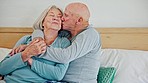 Senior couple, hug and kiss in bedroom, care and funny laugh together at home. Love, elderly man and happy woman in bed, embrace and connection for support, relationship and commitment to marriage