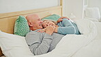 Senior, cuddle and happy couple in bed, care and embrace together in home. Love, elderly man and woman in bedroom for connection, support and healthy relationship, conversation or relax in retirement