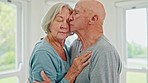 Dance, kiss and senior couple hug in their home with support, trust and respect, bond and music. Gratitude, connection and elderly people embrace in calm moment with care, love and romantic fun