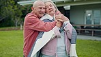 Nature, blanket and senior couple hugging, bonding and cuddle together in backyard garden. Happy, smile and elderly man and woman in retirement embracing with love, care and romance in outdoor park.