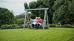 Senior couple on swing in garden with love, conversation and bonding with trees, grass and care. Relax, old man and woman in backyard, talking and drinking coffee with happy marriage in retirement.