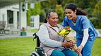 Gift, wheelchair and caregiver with flowers for senior woman in a disability retirement home garden together for care. Present, hug and nurse giving elderly person bouquet as kindness and support