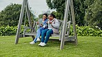 Happy woman, nurse and patient on tablet at park, bench or swing for entertainment in nature together. Female person or medical caregiver sitting outdoor with senior, technology or coffee for support