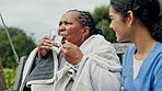 Pills, caregiver and drinking water with senior woman outdoor with wellness and health. Nurse, elderly female patient and drugs with medicine and healthcare in a garden at retirement home with help