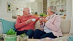 Coffee, senior couple and talking in living room with marriage, conversation and relax on a sofa. Discussion, tea cup and elderly people together in retirement with love and care in a home with drink