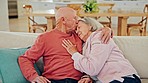 Senior couple, hug and home with forehead kiss, support and care on a sofa in retirement with marriage. Lounge couch, smile and relax with a woman and calm man with rest in a living room with embrace