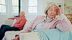 Senior couple, conflict and sofa in sofa, stress and anxiety with headache, worry and anger in living room. Elderly woman, old man and sad on lounge couch with fight, depression and thinking in house