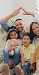 Face, home and family with love, security and safety with insurance, body language and smile. Portrait, mother and father with children, kids on the ground and happiness with investment and mortgage