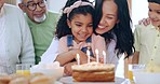 Happy family, little girl and hug for birthday cake, celebration or candles in joy for special day together at home. Mother, grandparents and children hugging for love, care or make a wish at house