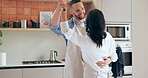 Dancing, home and couple with love, marriage and anniversary with happiness, romance or care. Romantic, man or woman in a kitchen, celebration or bonding together with joy, relationship or commitment