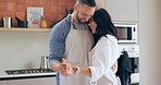 Dancing, home and couple with love, celebration and anniversary with happiness, marriage and care. People, man and woman in a kitchen, energy and bonding together with joy, relationship or commitment