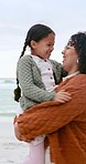 Family, playing and mother with child at beach for bonding, relationship and spinning in nature. Ocean, travel and happy mom with girl on holiday, vacation and weekend for relax, fun and adventure