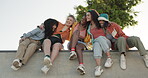 Friends, group and hug outdoor with laughing, care or relationship in summer for bonding or happiness. People, girls and sitting on a park with embrace, diversity and conversation for quality time