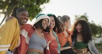Friends, group and hug outdoor with happiness, care and relationship in summer for bonding or support. People, girls and sitting on a park with embrace, diversity and laughing for quality time or joy