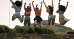 Happy woman, friends and jumping in air for celebration, freedom or fun day together in outdoor nature. Rear view of female people or excited group jump in friendship, success or holiday trip outside