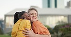 Happy woman, interracial friends and hug in trust, support or love for outdoor friendship together. Friendly female person hugging with smile for care, embrace or unity outside an urban town or city