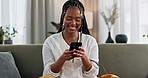 Black woman on sofa, relax or typing on phone for meme, social media or blog post with smile in home. Happy girl on sofa with smartphone checking email, funny website or online chat in living room.