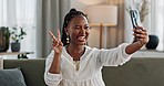 Smile, selfie and black woman with peace sign, funny face and relax on sofa in living room. V hand, picture and happy African person or influencer at home on couch on social media with tongue out