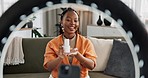 Video, content creator and black woman doing skincare for tutorial on social media or the internet. Dermatology, happy and African female influencer filming or live streaming face routine at home.