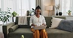 Black woman on sofa, smile and typing on laptop for remote work, social media or blog post research in home. Happy girl on sofa with computer checking email, website or online chat in living room.