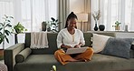 Black woman on sofa, smile and typing on laptop for remote work, social media or blog post research in home. Happy girl on couch with computer checking email, website or online chat in living room.