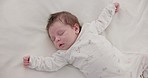 Cute, sleeping and newborn baby on a bed at a home in the bedroom for resting and dreaming. Tired, sweet and top view of infant, child or kid taking a nap in the morning in nursery at family house.