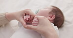 Bed, holding hands and mother with baby, love and support for care, health and wellness at home. Fingers, family or mama with a healthy infant, protection and child development with bond or maternity