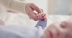 Parents, family and holding hands with baby on bed for bonding, love and relationship with infant. Adorable, cute and closeup of mom with hand of newborn for support, wellness and protection at home