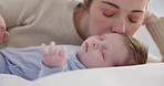 Family, love and a mother on the bedroom with her baby for sleep, rest or bonding together in a home. Children, bed and a woman in an apartment with her newborn infant to relax for care or growth