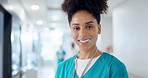 Happy woman, doctor and smile at hospital for healthcare, support or career ambition in hallway. Portrait of female person, nurse or medical professional for care, health advice or nursing at clinic