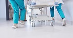 People, doctor and legs running with bed for emergency, ICU or quick surgery to save a life at hospital. Closeup of medical group or shoes in rush with stretcher for healthcare, urgency or support