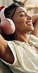 Happy woman, headphones and dance to music on a sofa for stress relief, relax or streaming at home. Eyes closed, break and Indian female person with radio earphones, podcast or chill audio in a house