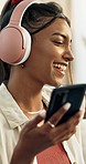 Phone, music and happy woman dance with headphones at home for stress relief, break or fun while streaming. Smartphone, app and female person with feel good, radio or audio podcast in a living room