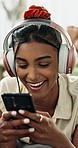 Phone, search and woman with music, headphones or text at home for social media, chat or communication. Smartphone, app and female person relax in a living room with podcast, radio or audio streaming