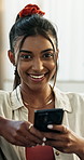 Woman, face and phone with smile for typing, communication or text message on sofa in living room. Indian, young person and smartphone for networking, research or social media on couch in lounge