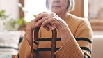 Home, closeup and senior woman with a walking stick, relax and retirement in a living room. Person with disability, pensioner and elderly lady on a couch, cane and resting with health and wellness